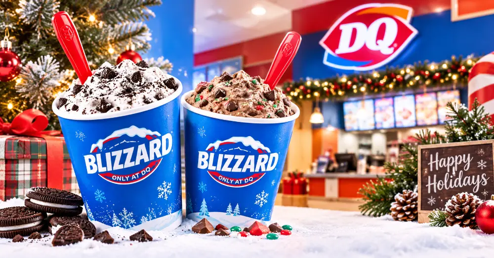 Two Dairy Queen Blizzard treats on a festive holiday display with a Christmas tree and Happy Holidays sign inside a DQ store
